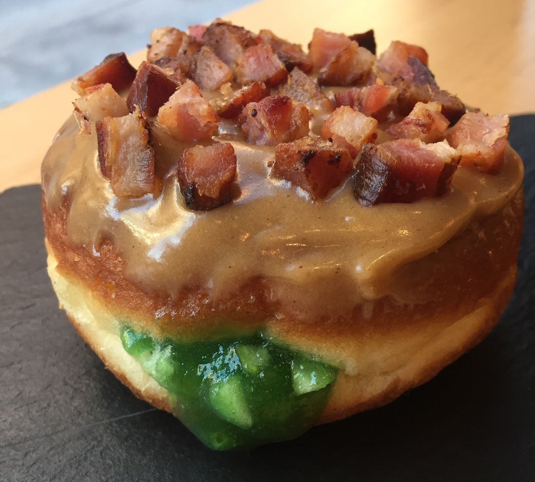 Jalapeo and apple filled doughnut with peanut butter glaze with a Nueske bacon topping, inspired by Quality Eats<br>